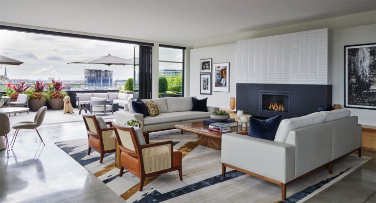 geometric design rug From The shape collection in a stunning nyc high-rise home. cream, blue and brown rug.
