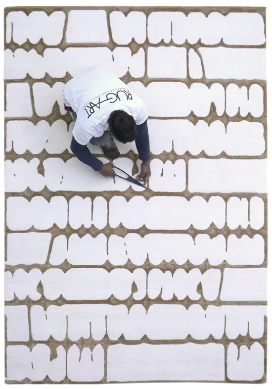 artisans refining the pattern of the Sonata custom rug during finishing